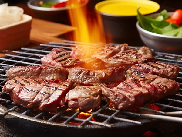 Juicy grilled steaks on a barbecue grill, showcasing a perfect sear and smoky flames.